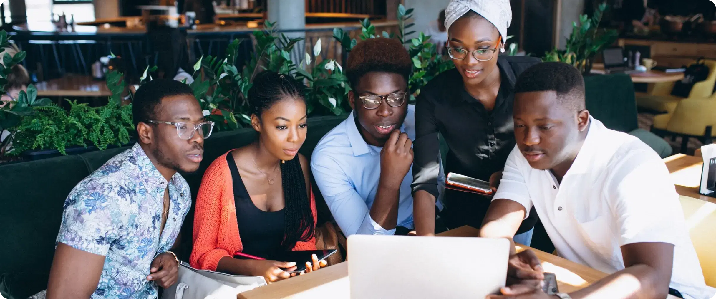 5 people looking at a screen