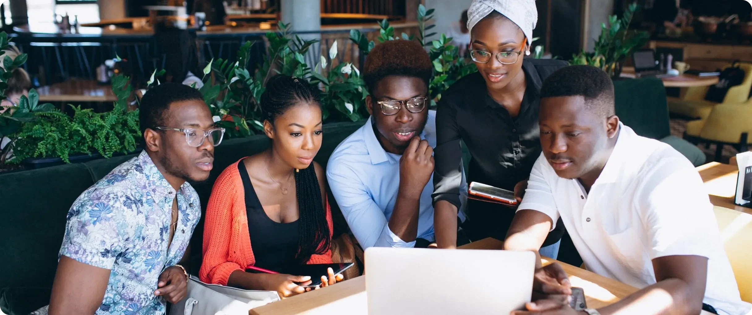 5 people looking at a screen