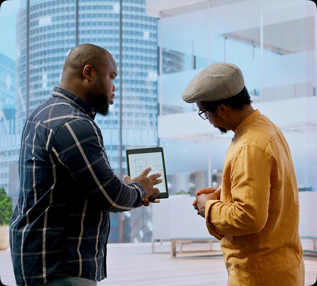 two men discussing over a tab
