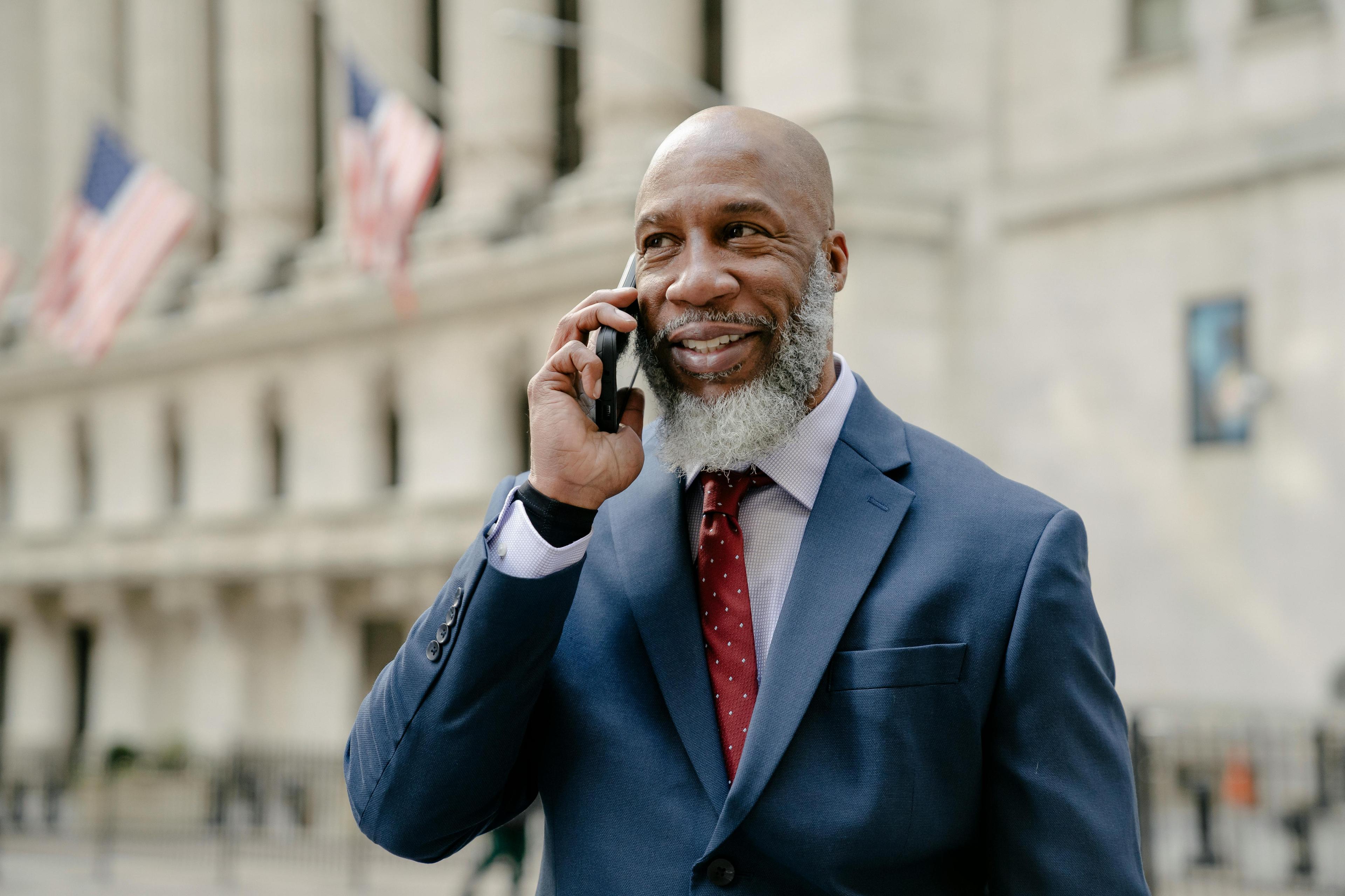 man talking on phone to agent about property
